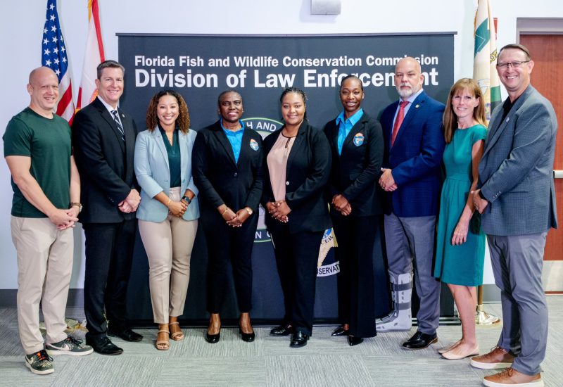 BTT Board Member Noah Valenstein; FWC Executive Director Roger Young; Jonisha Cartwright of The Nature Conservancy, who, with WildAid, sponsored BahWEN Force Chief Petty Officer and Chief Training Officer Deann Davis; BahWEN Lead Designate Commander Desiree Corneille (center) and BTT-sponsored Senior Lieutenant and Assistant to the BahWEN Lead Designate Danielle Morley; FWC Colonel Brian Smith; BTT VP of Conservation & Public Policy Kellie Ralston; 
and Greg Casad of WildAid.